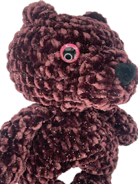 a brown teddy bear with pink eyes