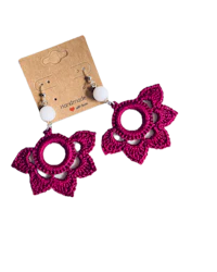 a pair of crocheted flower earrings with white beads