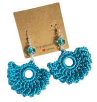 a pair of crocheted earrings with blue beads
