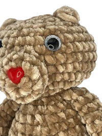 a brown teddy bear with a red nose